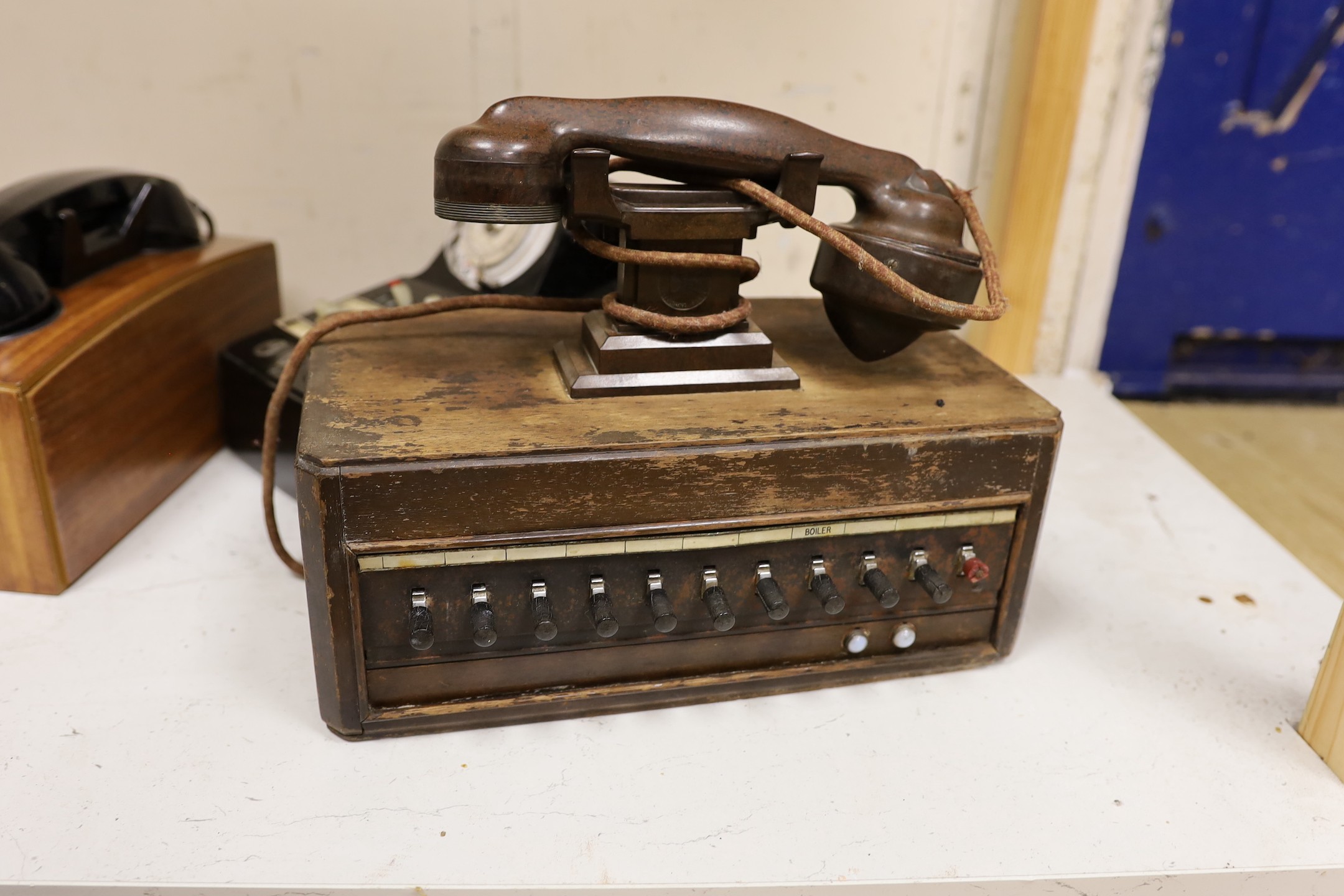 A 'switchboard' type Bakelite telephone together with two wooden cased examples (3)